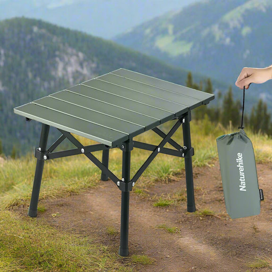Green folding camping table with black legs and a matching carrying bag on a white background, featuring the Naturehike brand.